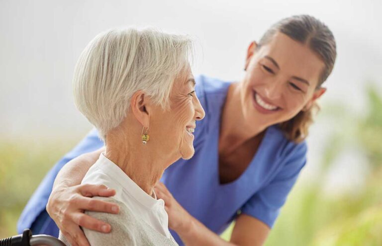 Family members speak with a staff member in a bright assisted living dining room during a tour.